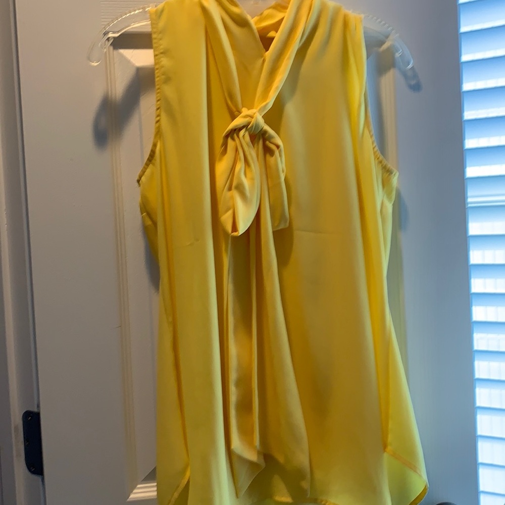 Yellow sleeveless blouse with necktie attached.
